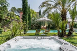 eine Whirlpool-Badewanne im Hof eines Hauses in der Unterkunft Gites de la Villa Pergola in Salernes