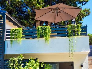 an umbrella hanging off the side of a building at Residence ǁ Corino in Biograd na Moru