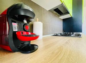 a red and black mixer sitting on a kitchen floor at Aventurescu Studio Brasov Coresi in Braşov +25 photos