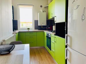 a kitchen with lime green cabinets and a window at Aventurescu Studio Brasov Coresi in Braşov +25 photos