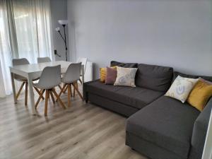 a living room with a couch and a table at Vilar d'Aro Apartment in S'Agaro