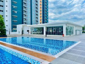 a swimming pool in front of a building at Alanis Suite with NETFLIX @ KLIA Sepang in Sepang