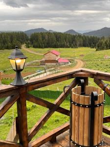 a lamp on a wooden fence with a view of a farm at Zifinbungalov in Akcaabat