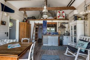 a kitchen and dining room with a table and chairs at Sjöstuga Myttinge in Värmdö