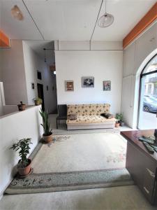 a living room with a couch and a window at Hostel Near The Square in Tbilisi City