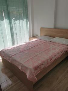 a bed with a pink blanket on top of it at IRINI'S HOUSE in Toroni