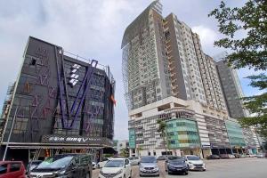 two tall buildings with cars parked in a parking lot at Paradise Sovo Austin Height in Johor Bahru