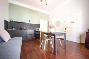 a living room with a table and a kitchen at Bramante 21 in Pesaro