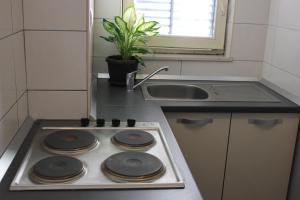 a stove top in a kitchen with a sink at Apartments Kike&Ana in Split
