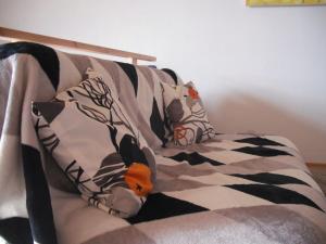 a couch with a blanket and a stuffed animal on it at Haus Sonnenblume in Weilheim