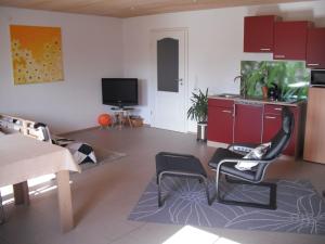 a living room with two chairs and a television at Haus Sonnenblume in Weilheim