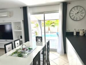 a kitchen with a large clock on the wall at VILLA PISCINE DE LA GARRIGUE in Florensac