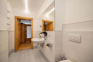 a bathroom with a sink and a toilet at Langstein Wohnung Lavendel in Coldrano