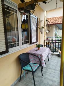 a table and chairs sitting on a balcony with a table and chairs at Christina's Home in Sarti