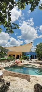 a swimming pool in front of a house at VILLA DEL CIELO TIXPEHUAL in Tixpehual