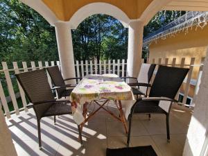 einen Tisch und vier Stühle auf einer Veranda in der Unterkunft Villa Letícia Siófok in Siófok