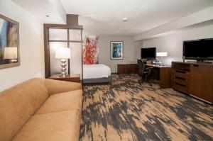 a hotel room with a couch and a bed and a desk at Fairfield Inn & Suites by Marriott Dallas DFW Airport South/Irving in Irving