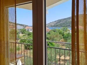 a room with a window with a view of the ocean at Apartments Neli in Vinišće