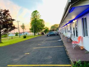 a car parked in a parking lot next to a building at Carleton Motel and Coffee Shop in Borden-Carleton