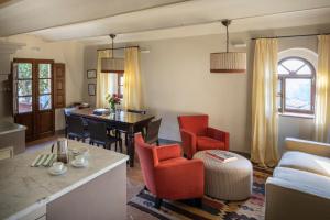 a living room with a couch and a table and chairs at Borgo Pignano in Pignano