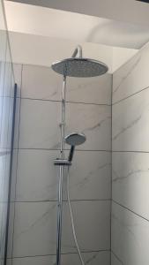 a shower with a shower head in a bathroom at Prestige Worldwide Apartments in Ayia Napa