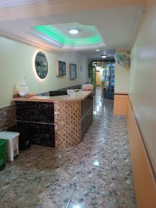 a lobby with a bar with a tile floor at Hotel Costa mar in Barranquilla