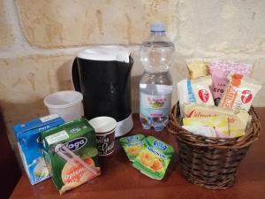 a table with a basket of snacks and a bottle of water at Le Tre Stelle in Cagliari