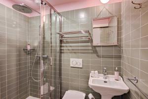 a bathroom with a shower and a sink and a toilet at Aparthotel AMMI Vieux Nice in Nice