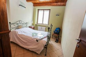 a small bedroom with a bed and a window at Casa San Carlo in Caraglio