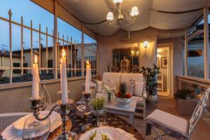 a patio with a table and chairs on a balcony at CASA UCCELLINI with a Romantic Terrace in Lucca