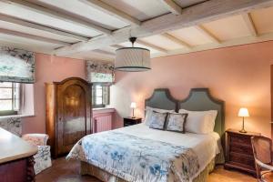 a bedroom with a bed and a table and chairs at Borgo Pignano in Pignano