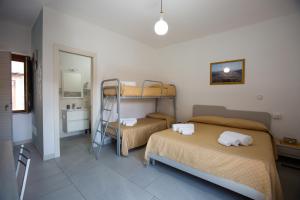 a bedroom with two bunk beds and a mirror at Nonno Giovanni in Gangi