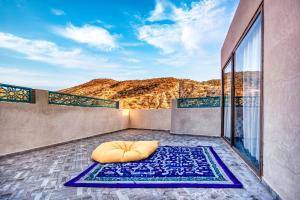 a bed on a balcony with a view of the mountains at Route de Miel in Agadir