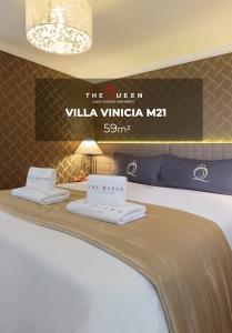 a hotel room with two towels on a bed at The Queen Luxury Apartments - Villa Vinicia in Luxembourg