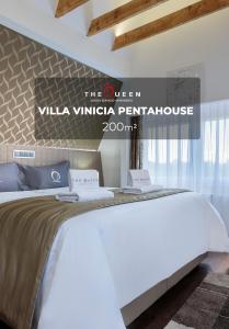 a bedroom with a large white bed in a room at The Queen Luxury Apartments - Villa Vinicia in Luxembourg