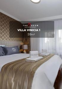 a hotel room with a bed with two towels on it at The Queen Luxury Apartments - Villa Vinicia in Luxembourg