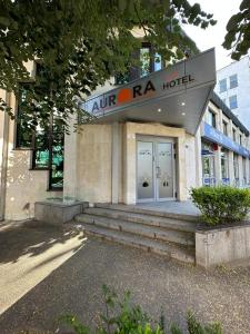 a naosa hotel with stairs in front of a building at Хотел АВРОРА in Haskovo