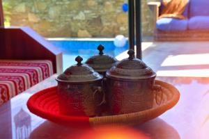 two tea pots on a plate on a table at Route de Miel in Agadir