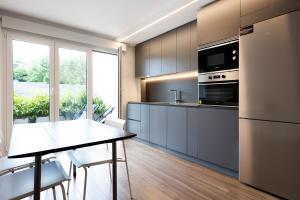 a kitchen with a table and a refrigerator at Kofradia in Hondarribia