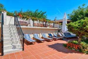 a row of chairs on a patio next to a staircase at Alekta Hotel - Free parking in Varna City