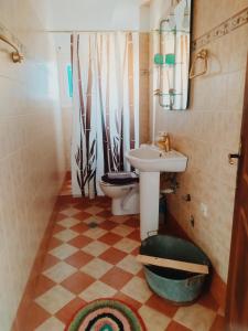 a small bathroom with a sink and a toilet at Villa Irene in Kalymnos