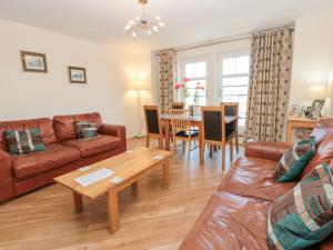 a living room with a couch and a table at Harbour Lodge in Whitby