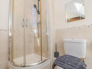 a bathroom with a shower and a toilet at Harbour Lodge in Whitby +19 photos
