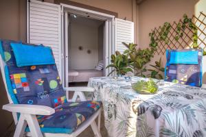 two chairs and a table with a tablecloth on a patio at Leas House in Preveza