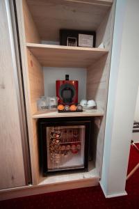 a small refrigerator with a wine rack in it at Km ZerO - Vama Veche in Vama Veche