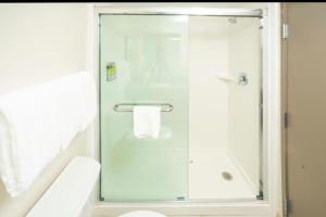 a shower with a glass door in a bathroom at Candlewood Suites Charleston – Mt. Pleasant by IHG in Charleston +55 photos