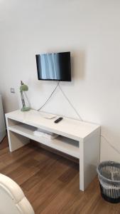 a white table with a tv on top of it at Marchesa Lulu in Salerno