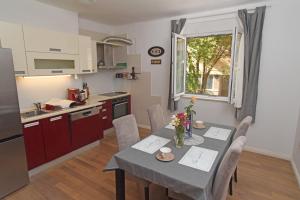 a kitchen and dining room with a table and chairs at Apartment Toro in Split