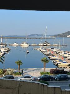 a bunch of boats parked in a marina with palm trees at FZin Suite in Kavala
