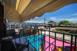 a balcony with a view of a swimming pool at Km ZerO - Vama Veche in Vama Veche